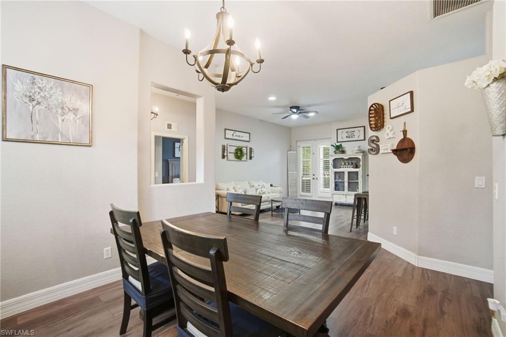2900 Orange Grove Trail Naples, FL 34120 - Photo 12 of 46 a view of a dining room with furniture and wooden floor