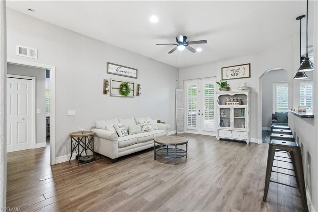 2900 Orange Grove Trail Naples, FL 34120 - Photo 13 of 46 a living room with furniture and wooden floor