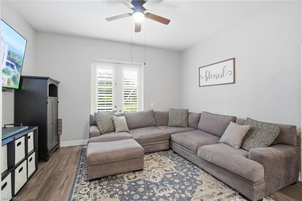 2900 Orange Grove Trail Naples, FL 34120 - Photo 18 of 46 a living room with furniture a flat screen tv and a window