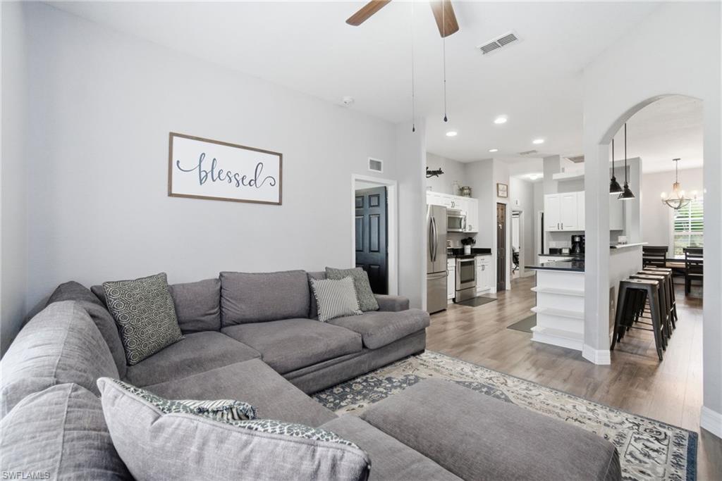 2900 Orange Grove Trail Naples, FL 34120 - Photo 19 of 46 a living room with furniture and a view of kitchen
