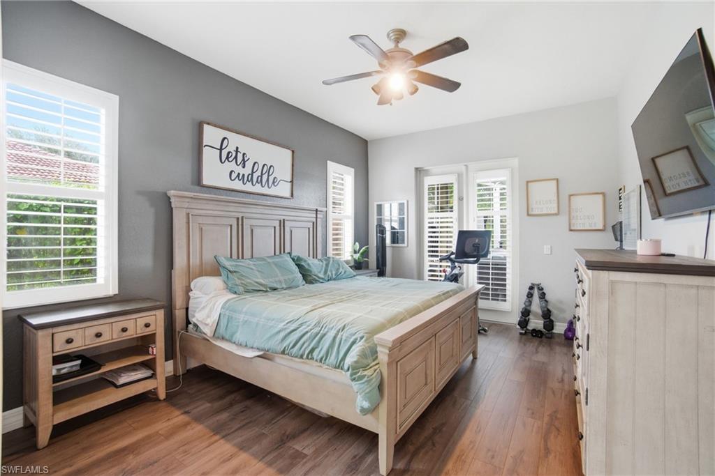 2900 Orange Grove Trail Naples, FL 34120 - Photo 20 of 46 a bedroom with a bed and a chandelier