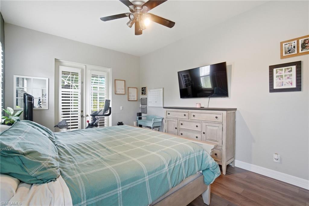2900 Orange Grove Trail Naples, FL 34120 - Photo 22 of 46 a bedroom with a bed and a flat screen tv