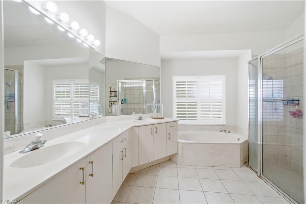2900 Orange Grove Trail Naples, FL 34120 - Photo 23 of 46 a spacious bathroom with a granite countertop bathtub a sink and a shower
