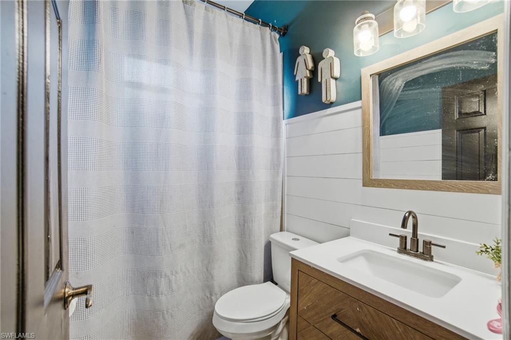 2900 Orange Grove Trail Naples, FL 34120 - Photo 30 of 46 a bathroom with a granite countertop sink vanity mirror and toilet