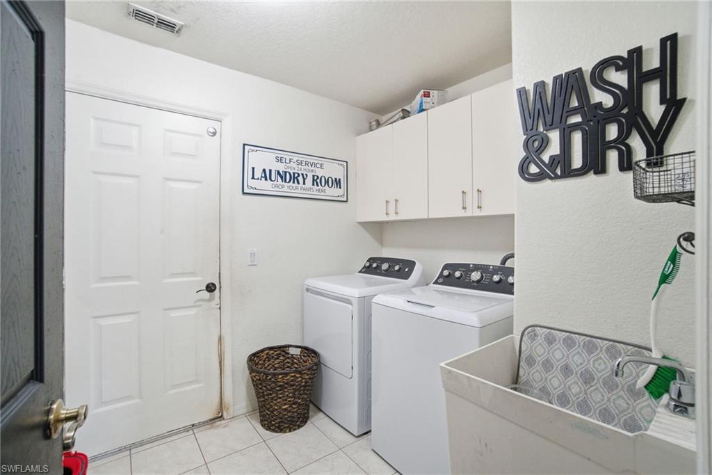 2900 Orange Grove Trail Naples, FL 34120 - Photo 31 of 46 a kitchen with a refrigerator and cabinets