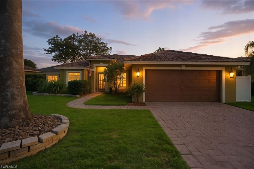 2900 Orange Grove Trail Naples, FL 34120 - Photo 4 of 46 a front view of a house with garden
