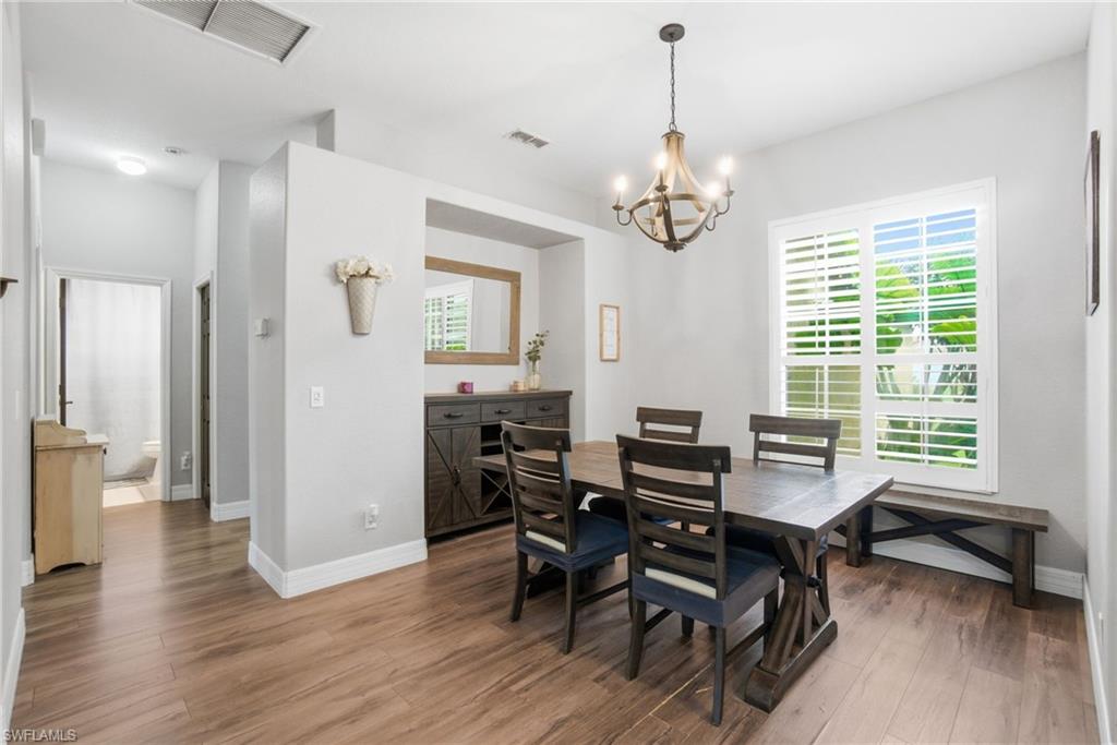 2900 Orange Grove Trail Naples, FL 34120 - Photo 10 of 46 a view of a dining room with furniture window and wooden floor