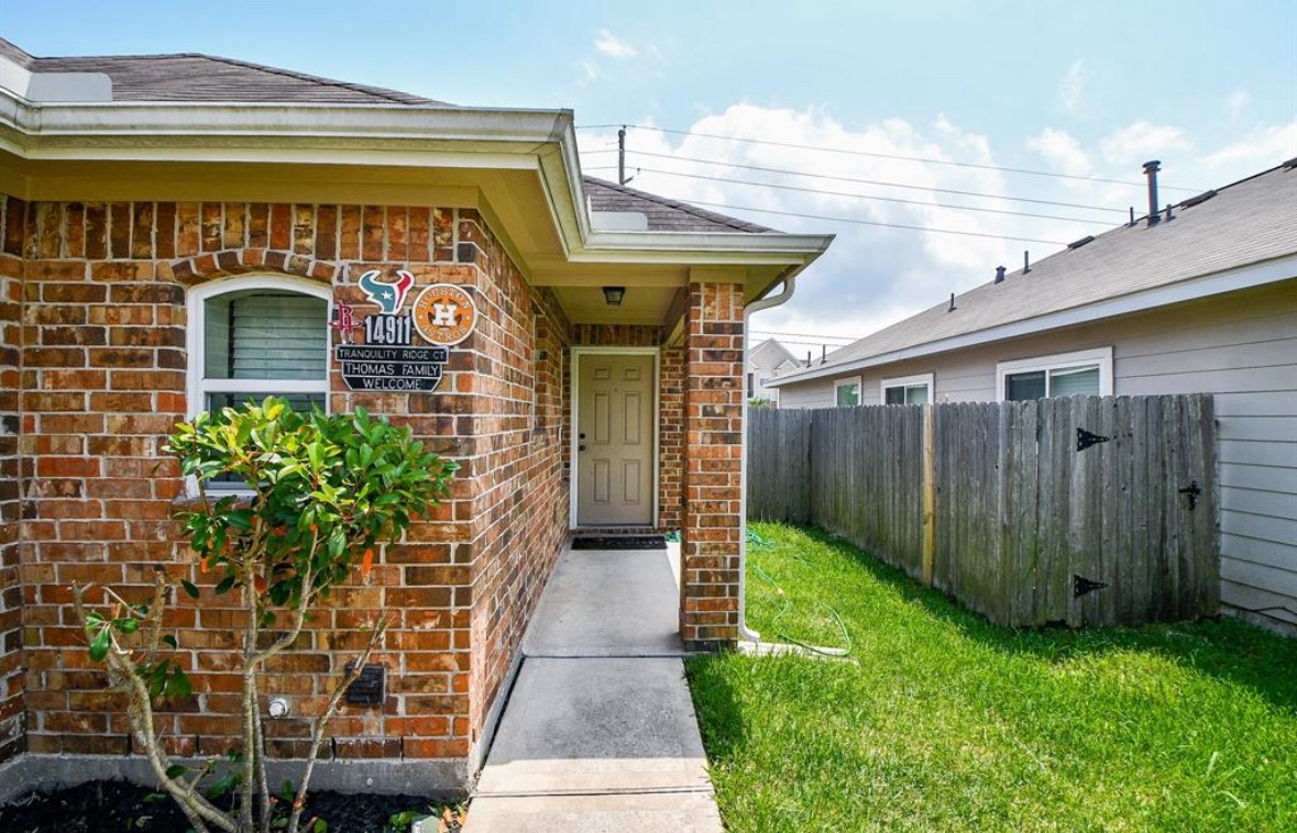 14911 Tranquility Ridge Court Humble, TX 77396 - Photo 2 of 8 a front view of a house with a garden
