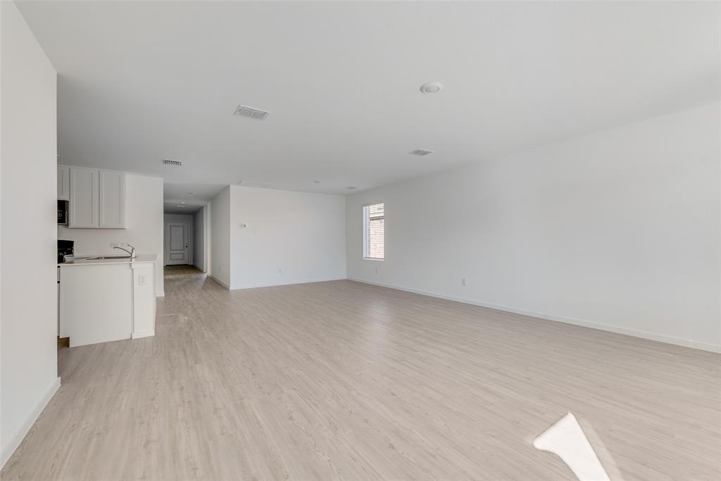 2051 Stable Lane Aubrey, TX 76227 - Photo 17 of 20 a view of empty room with wooden floor