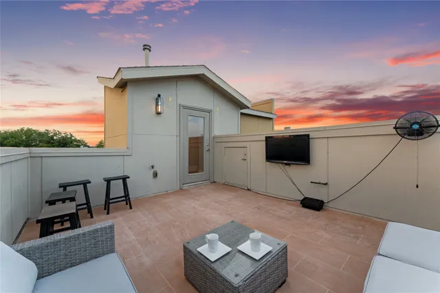 a view of a white house with a big yard and a fountain