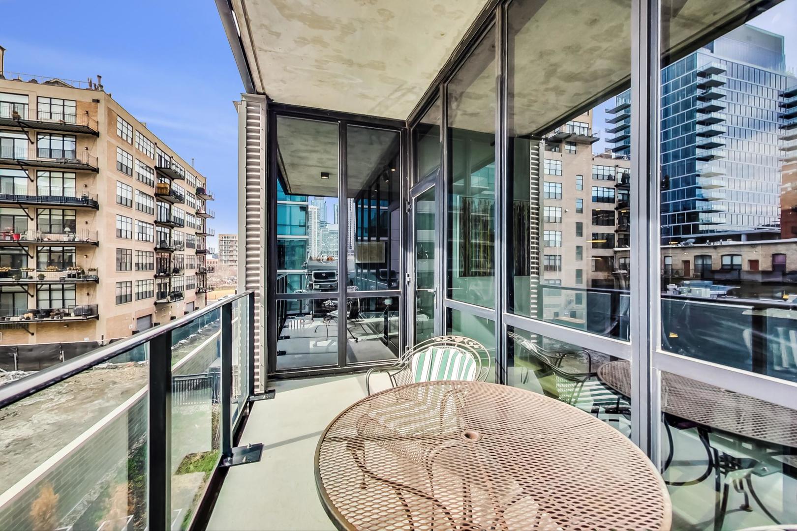 111 South Peoria Street, Unit 309 Chicago, IL 60607 - Photo 42 of 43 a balcony with table and chairs