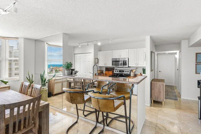 a bedroom with a bed and a lamp on dresser