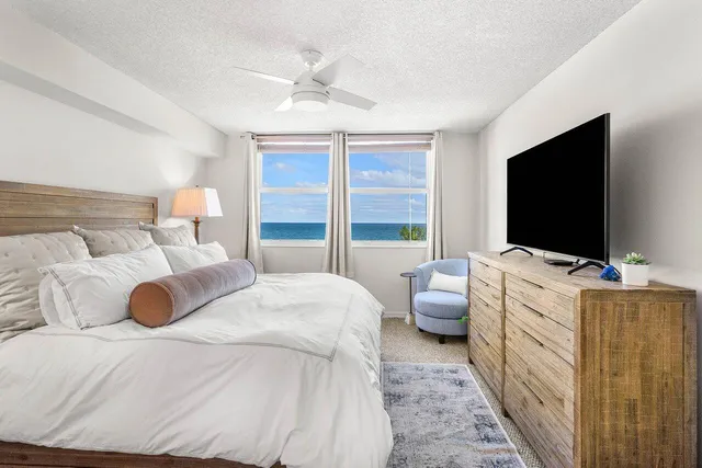 a large white kitchen with a large window