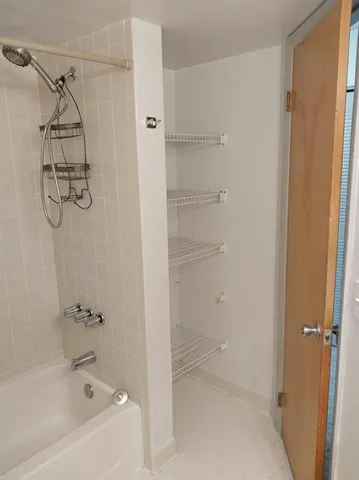 a bathroom with a bathtub and shower