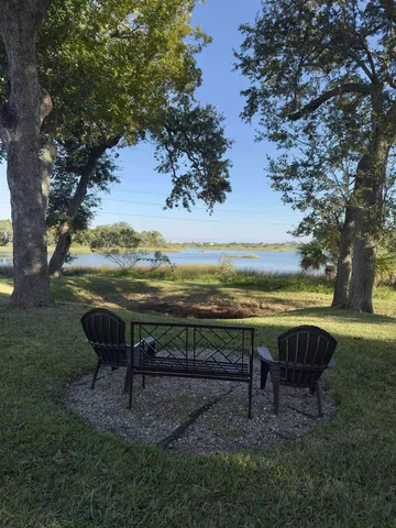 a view of a backyard with sitting area