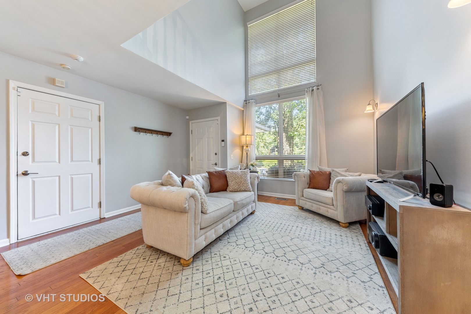 471 River Bend Road, Unit 103 Naperville, IL 60540 - Photo 2 of 29 a living room with furniture and a flat screen tv