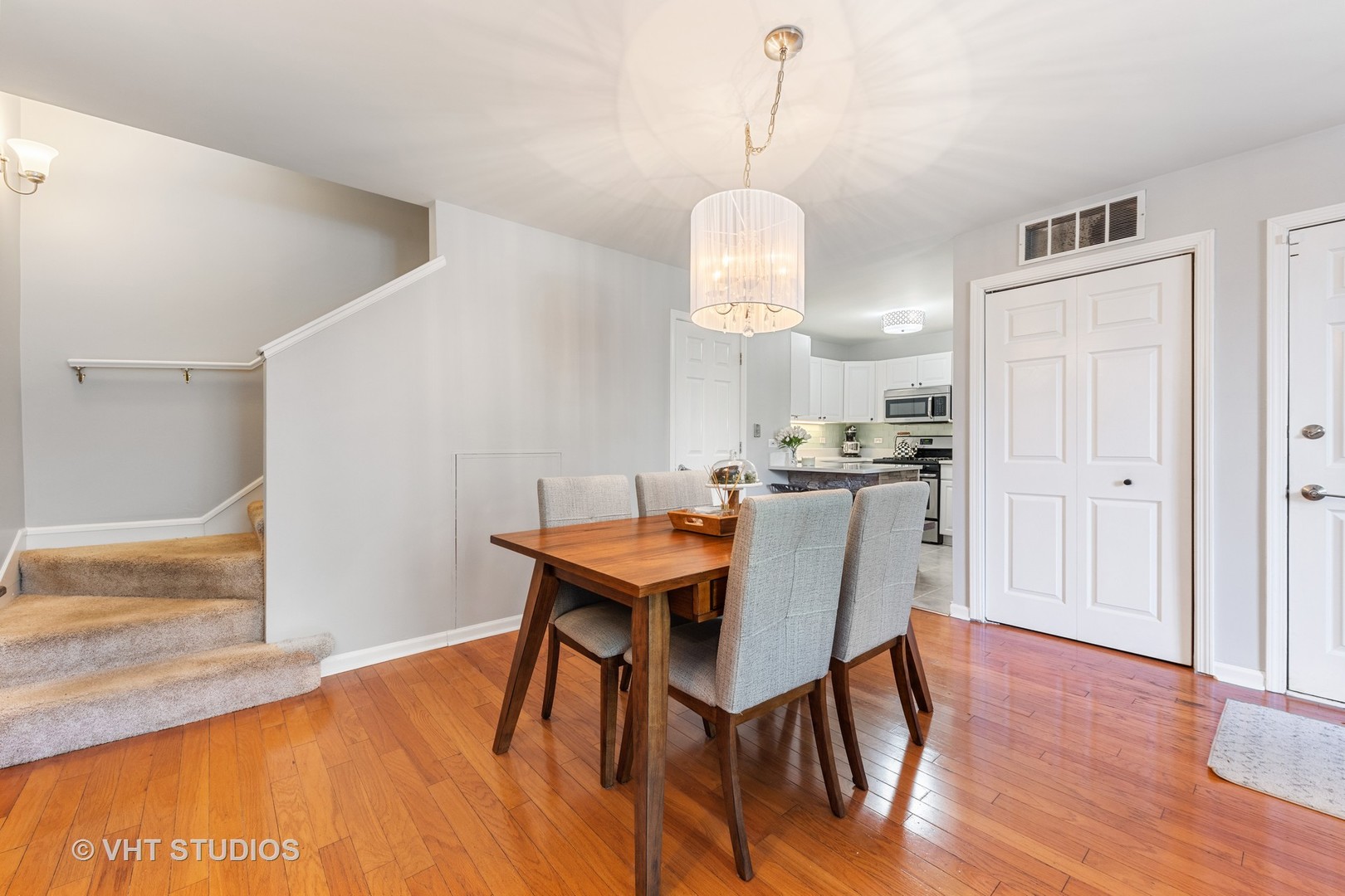 471 River Bend Road, Unit 103 Naperville, IL 60540 - Photo 4 of 29 a view of a dining room with furniture wooden floor and chandelier