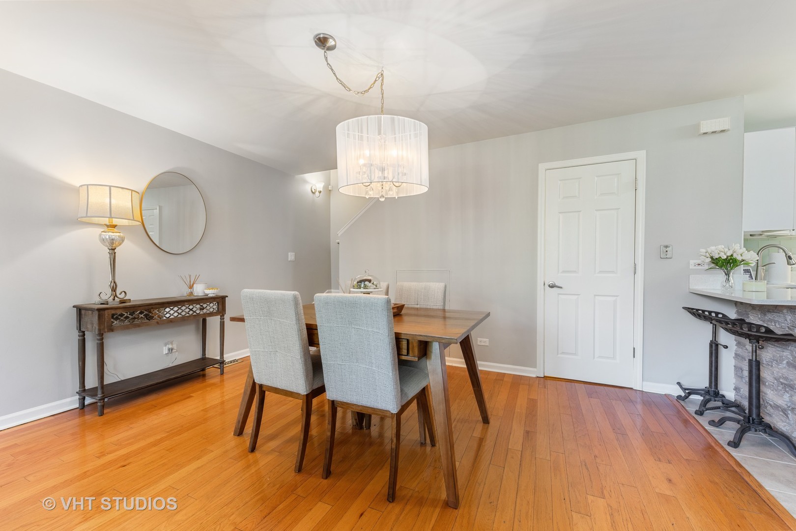 471 River Bend Road, Unit 103 Naperville, IL 60540 - Photo 5 of 29 a view of a dining room with furniture wooden floor and chandelier