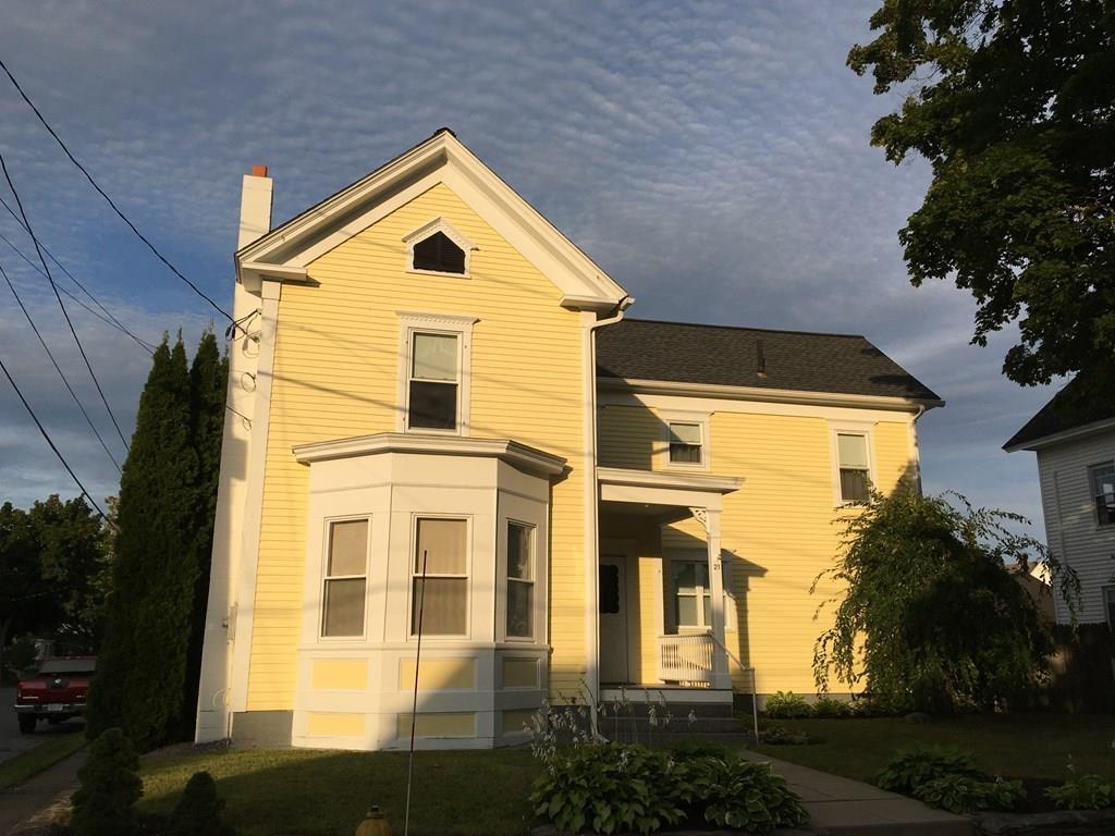 a view of a big house with plants and trees