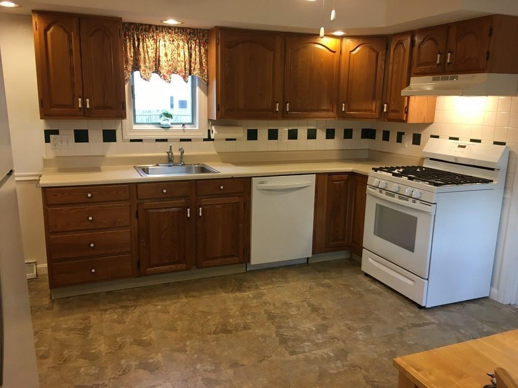 21 Whitman Street Leominster, MA 01453 - Photo 13 of 35 a kitchen with a sink stove and cabinets