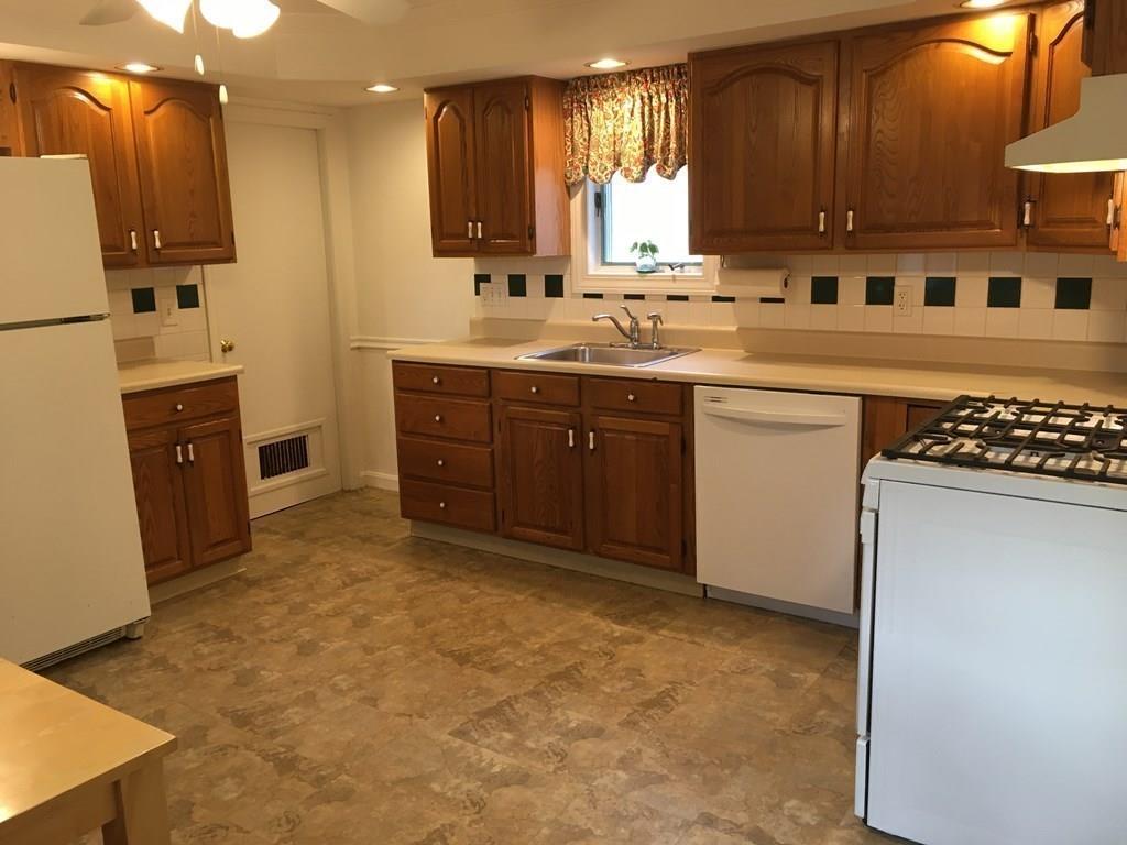 21 Whitman Street Leominster, MA 01453 - Photo 16 of 35 a kitchen with stainless steel appliances granite countertop a sink stove and refrigerator