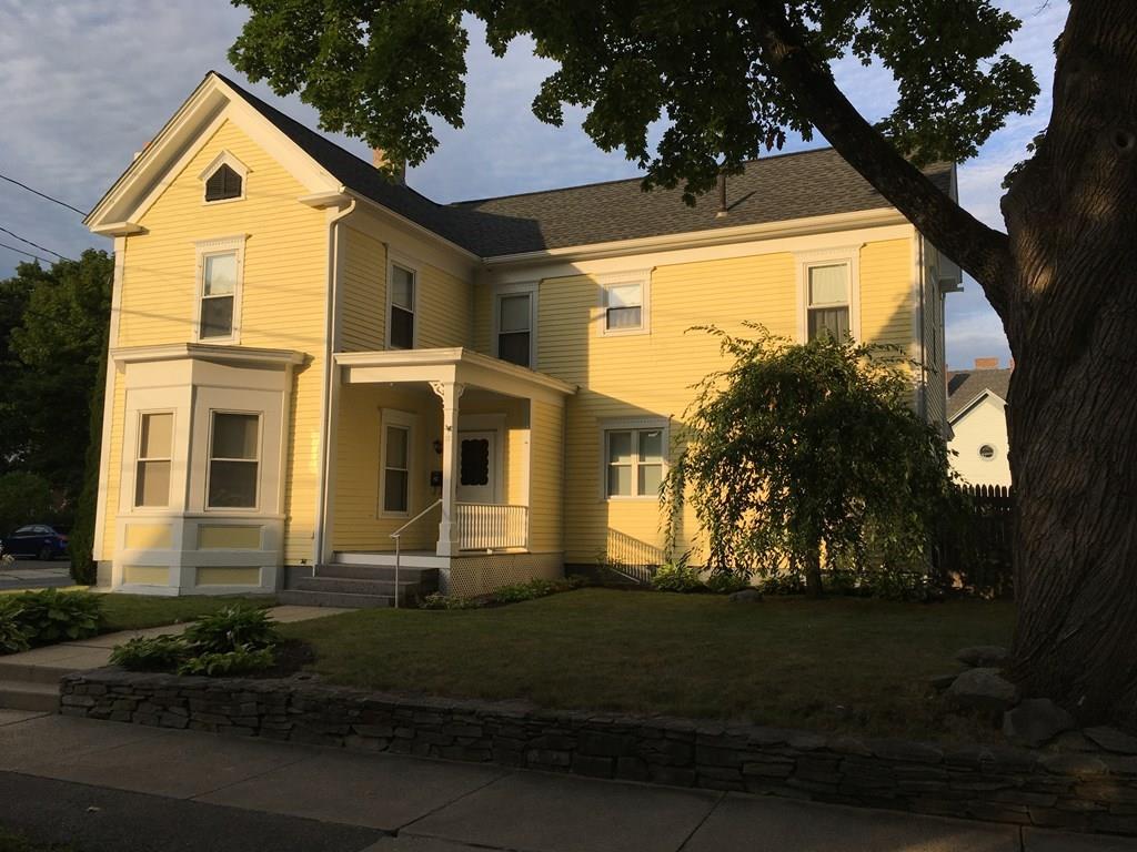21 Whitman Street Leominster, MA 01453 - Photo 2 of 35 a view of a white house with a large window and a yard