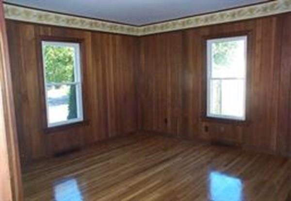 21 Whitman Street Leominster, MA 01453 - Photo 21 of 35 a view of an empty room with wooden floor and a window