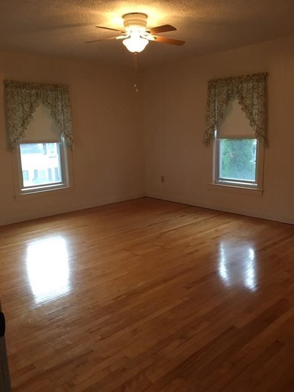21 Whitman Street Leominster, MA 01453 - Photo 22 of 35 an empty room with wooden floor and windows
