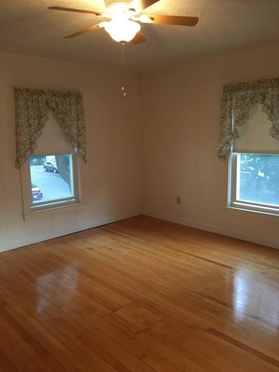 21 Whitman Street Leominster, MA 01453 - Photo 23 of 35 an empty room with wooden floor chandelier and windows