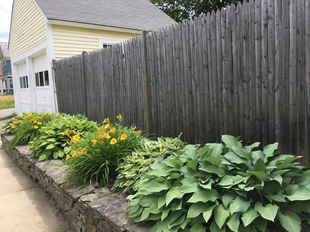 21 Whitman Street Leominster, MA 01453 - Photo 6 of 35 a backyard with potted plants and wooden fence