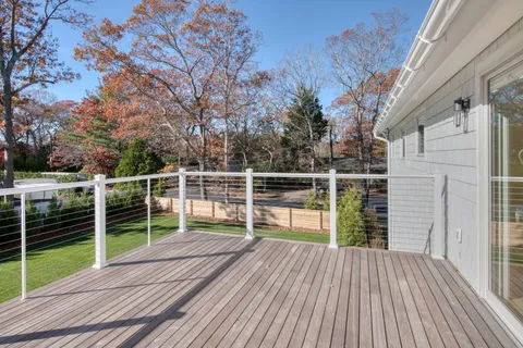a view of balcony with wooden floor and fence