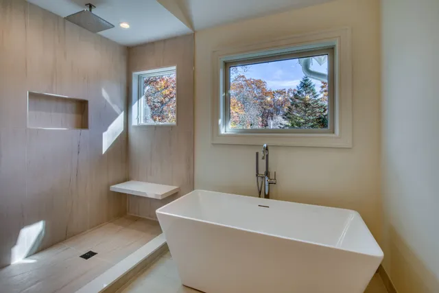 a white bath tub sitting next to a white toilet