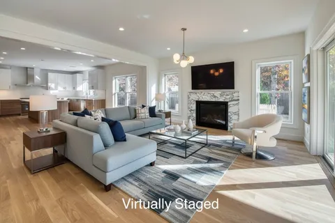 a bedroom with a large bed a rug and a large window
