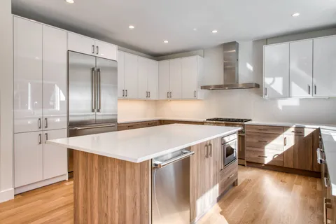 a kitchen with a stove a refrigerator and a sink