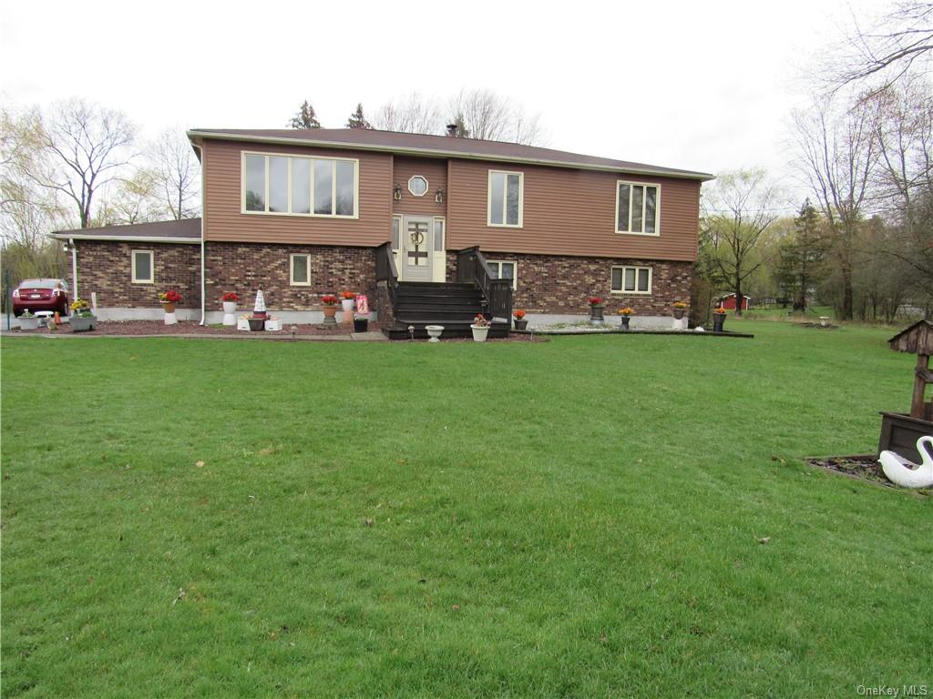 a front view of house with yard and seating area
