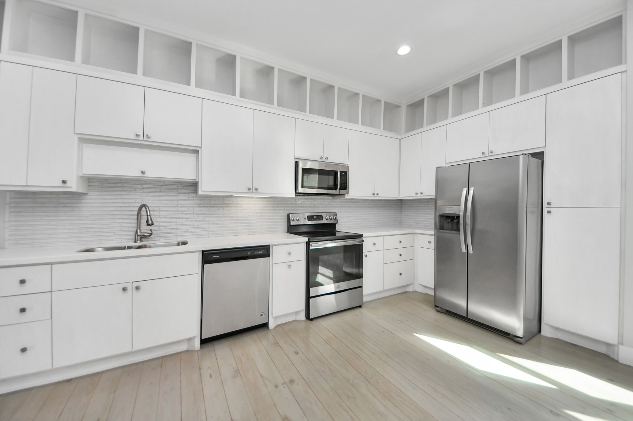 1708 Winter Street, Unit C Houston, TX 77007 - Photo 20 of 36 a kitchen with granite countertop white cabinets and stainless steel appliances