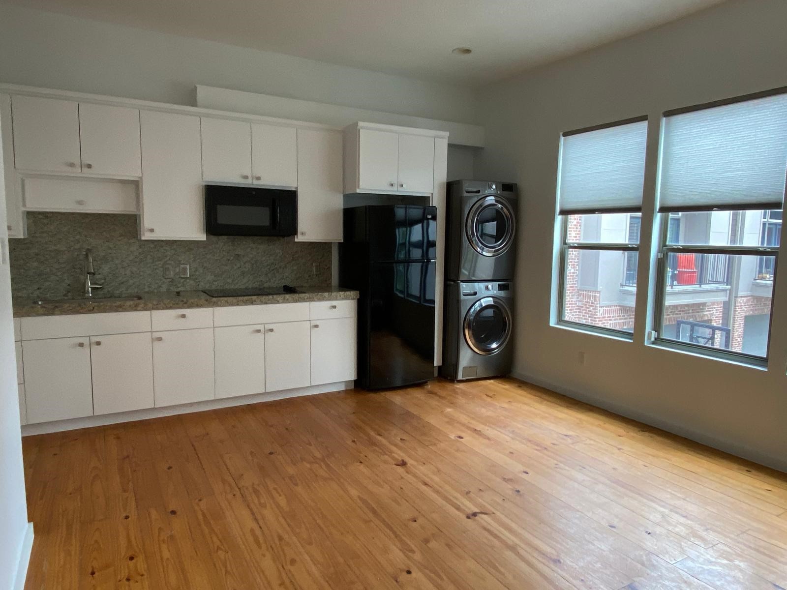 1708 Winter Street, Unit C Houston, TX 77007 - Photo 31 of 36 a kitchen with stainless steel appliances granite countertop a refrigerator and a stove top oven