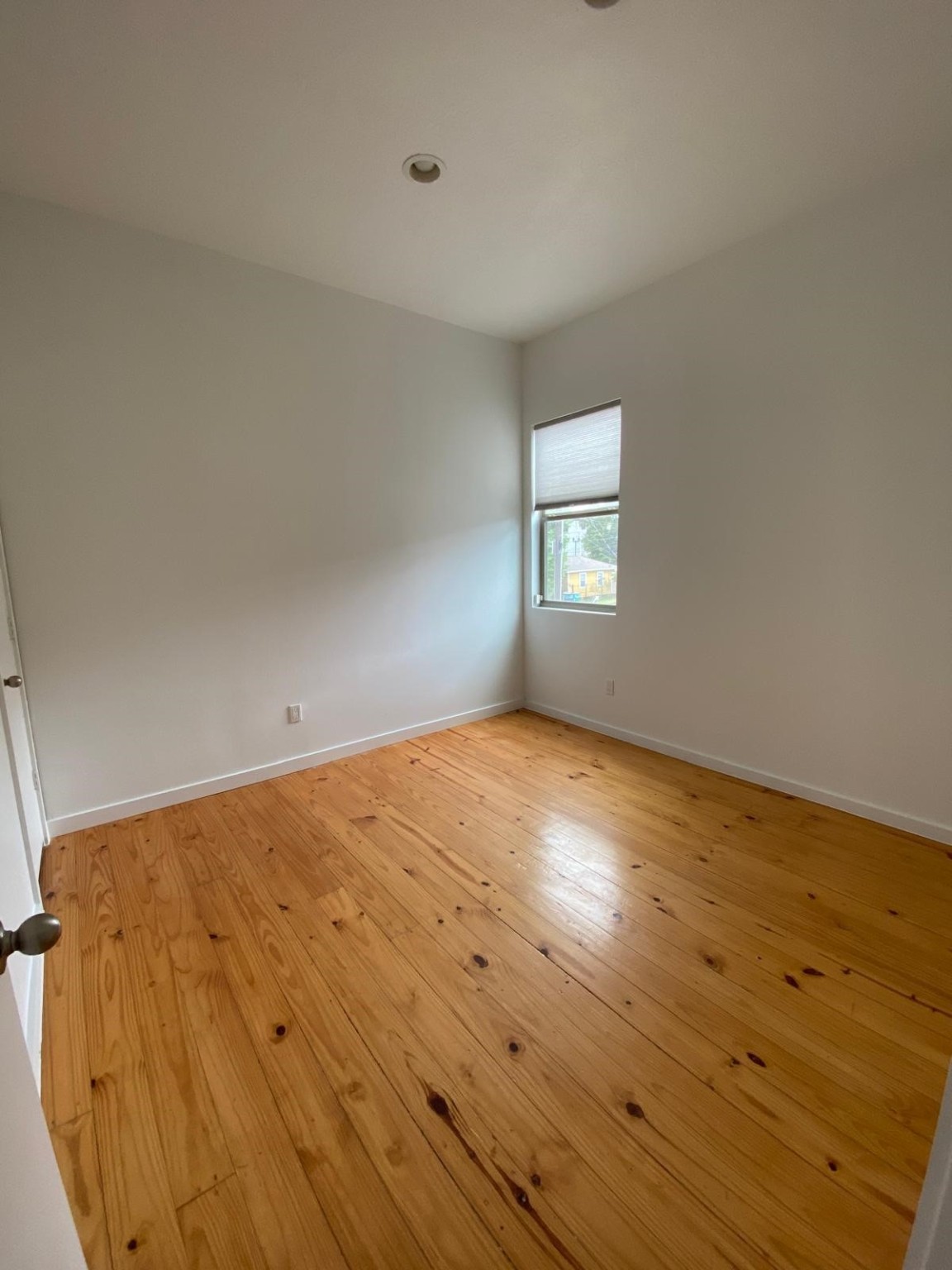 1708 Winter Street, Unit C Houston, TX 77007 - Photo 32 of 36 an empty room with wooden floor and windows