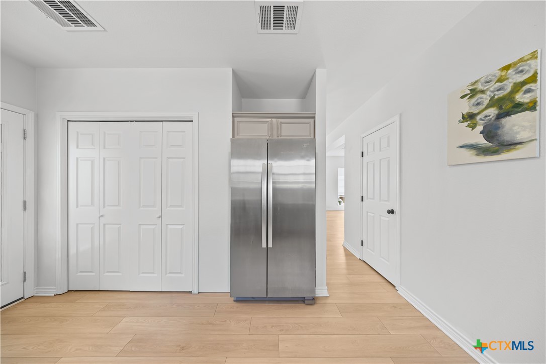 1710 Greening Way Leander, TX 78641 - Photo 14 of 47 a view of an empty room with wooden floor
