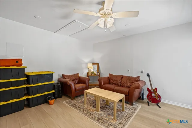 a living room with furniture ceiling fan and a rug