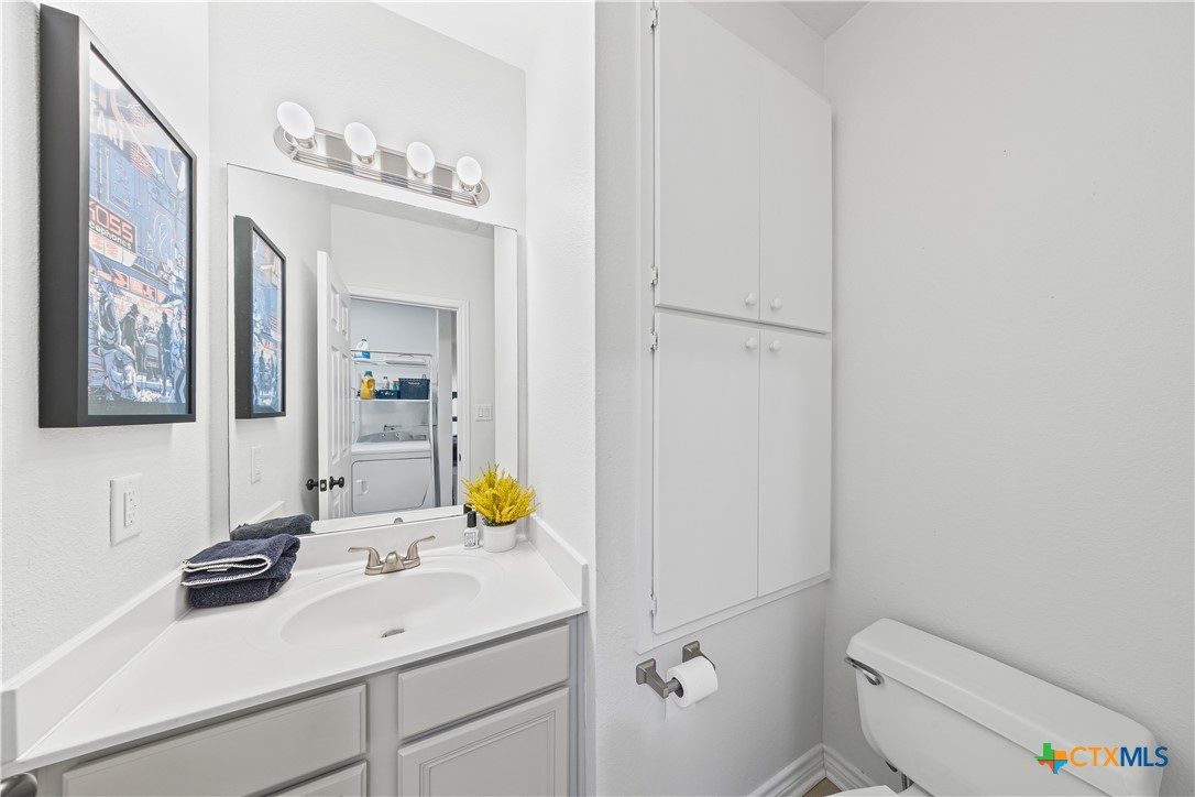 1710 Greening Way Leander, TX 78641 - Photo 20 of 47 a bathroom with a sink mirror vanity and toilet