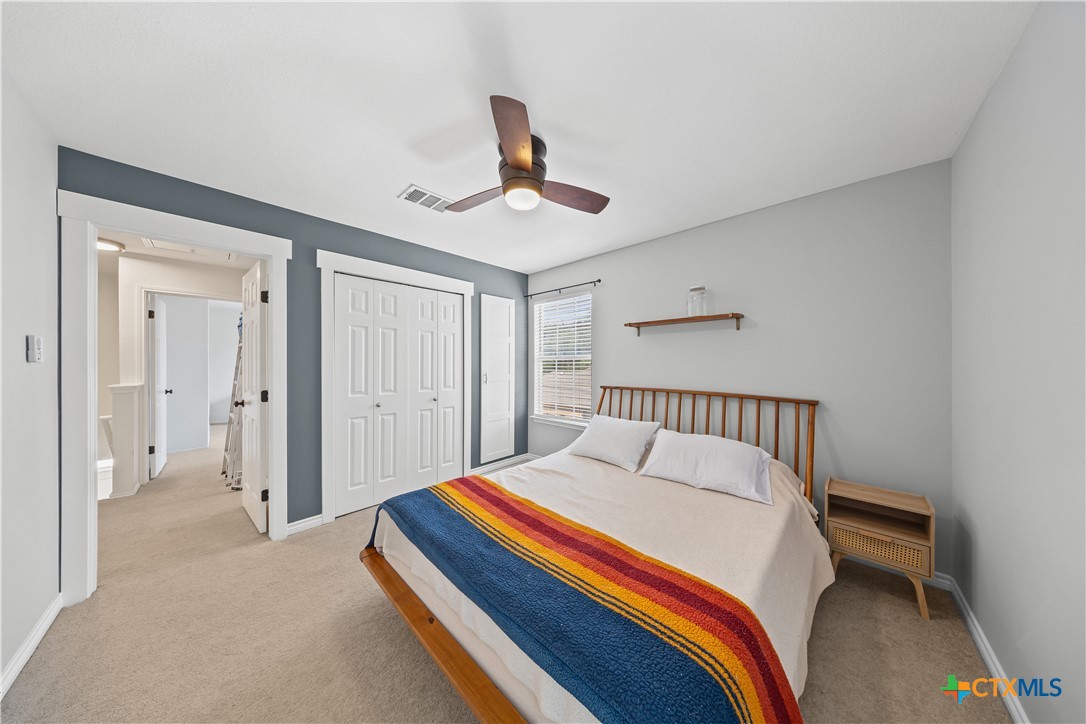 1710 Greening Way Leander, TX 78641 - Photo 22 of 47 a bedroom with a bed and a chandelier