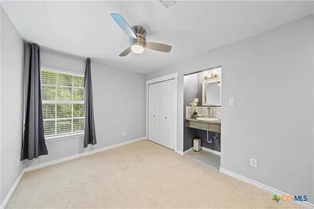 a view of a livingroom with a furniture and a ceiling fan