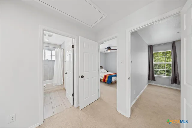 a bedroom with a bed and a window with outer view