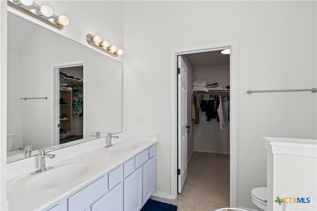 1710 Greening Way Leander, TX 78641 - Photo 35 of 47 a en suite bathroom with a sink a toilet and shower