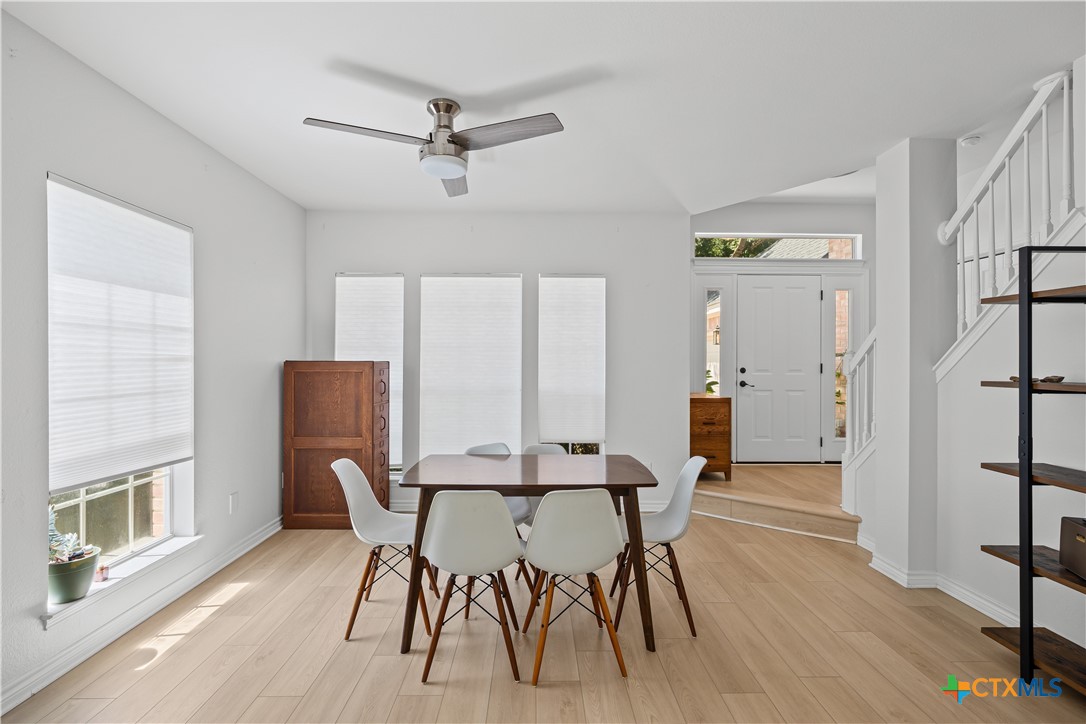 1710 Greening Way Leander, TX 78641 - Photo 5 of 47 a view of a dining room with furniture and wooden floor