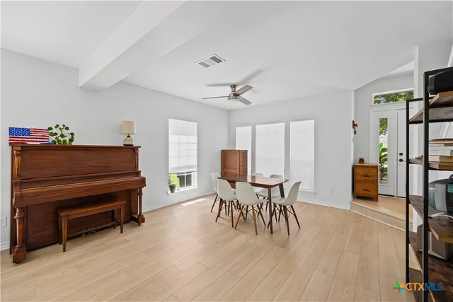 a dining room with furniture and wooden floor