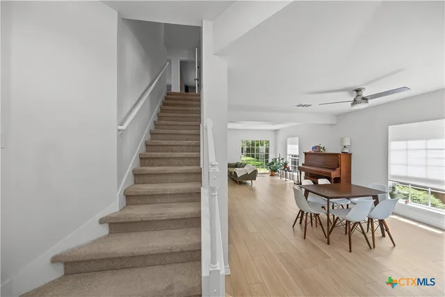 a view of a livingroom with furniture and a floor to ceiling window