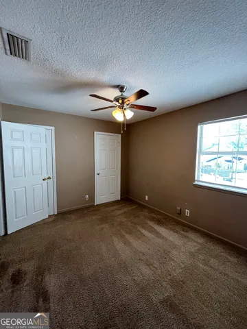 an empty room with a empty space and windows