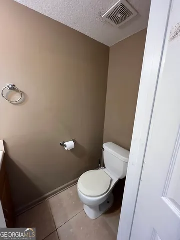 a white toilet sitting next to a white sink